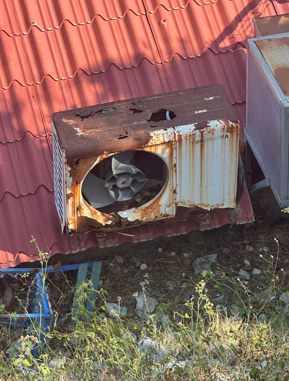 Engineer performing annual air conditioning service, cleaning filters and checking system components