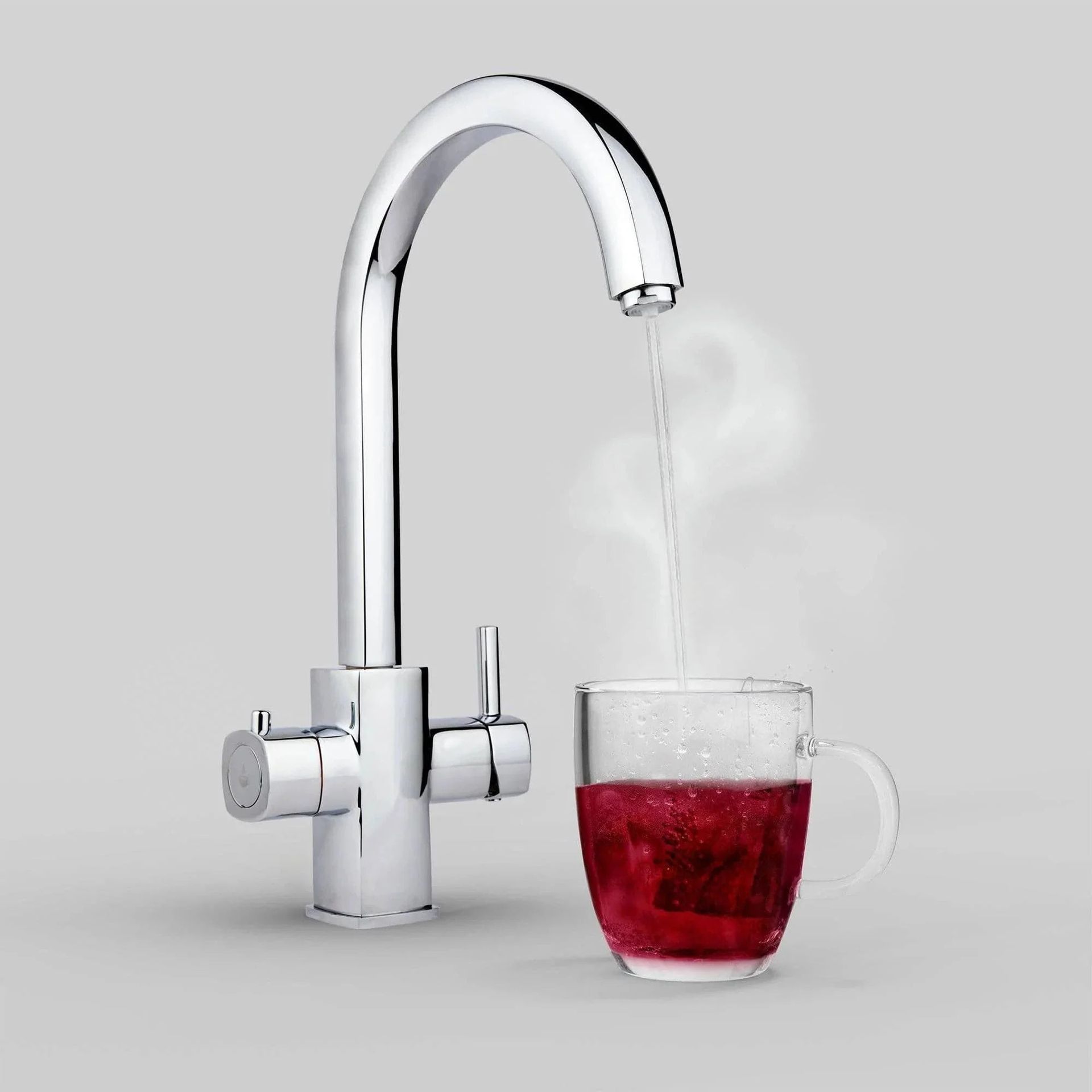 Boiling tap dispensing hot water into a mug on a clean worktop