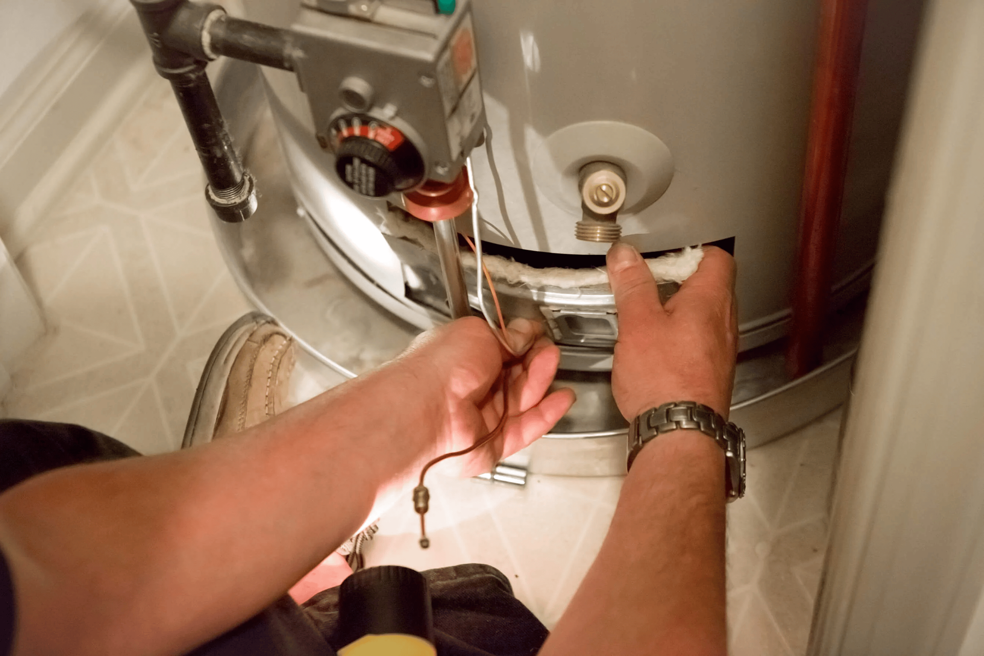 Hot water cylinder wiring fault being diagnosed by Lucas Plumbing technician