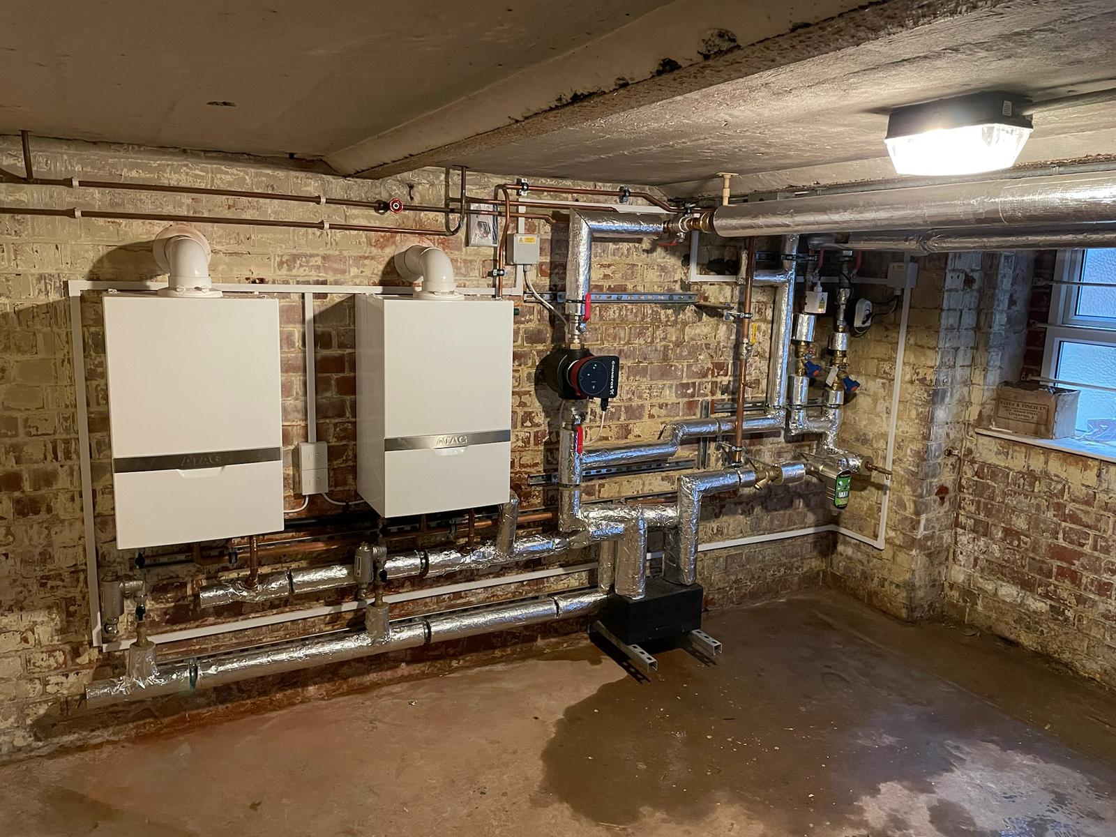 Condensing boiler mounted on wall with tidy pipework