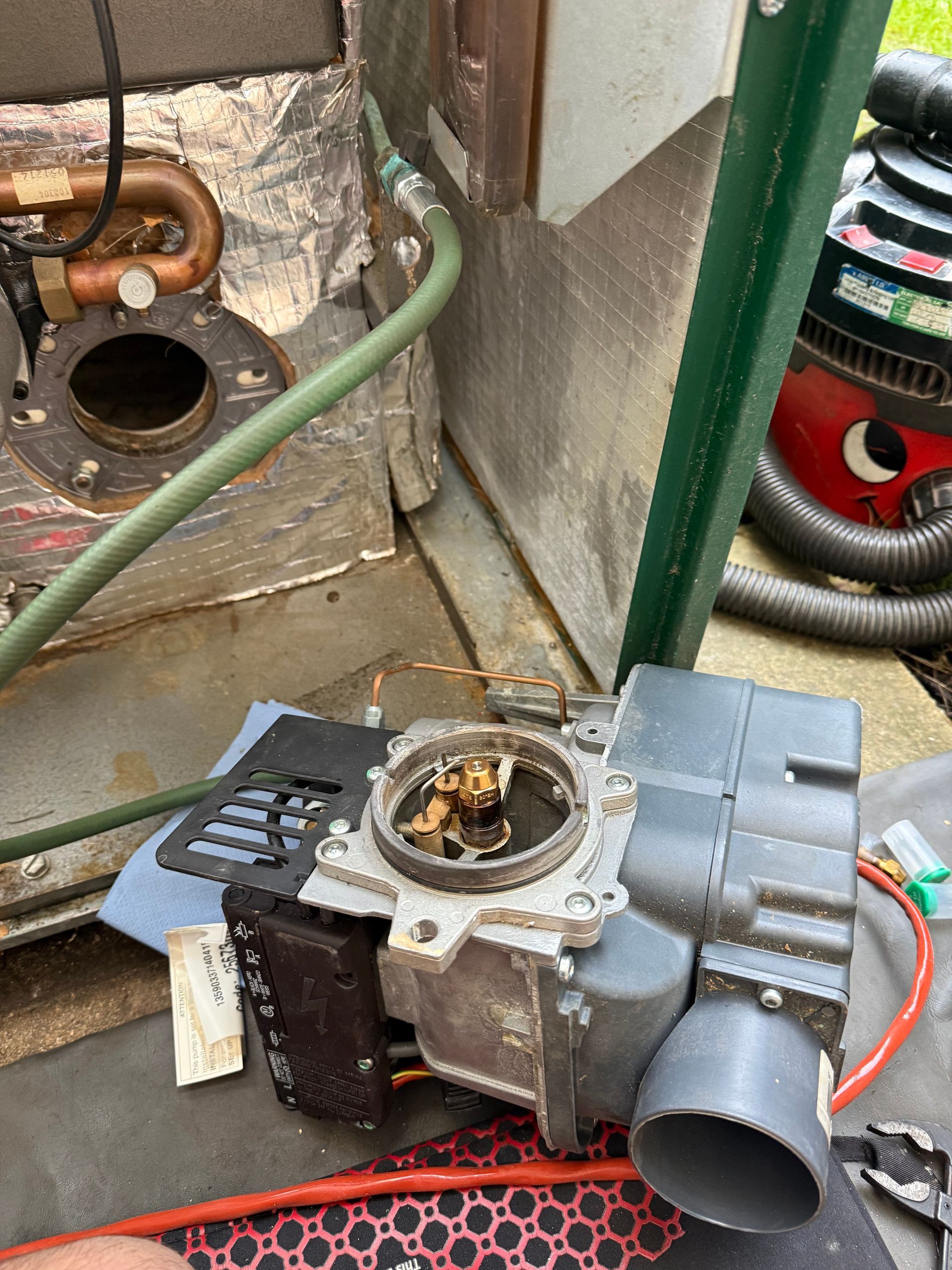 OFTEC-registered engineer repairing a domestic oil boiler during a heating breakdown.