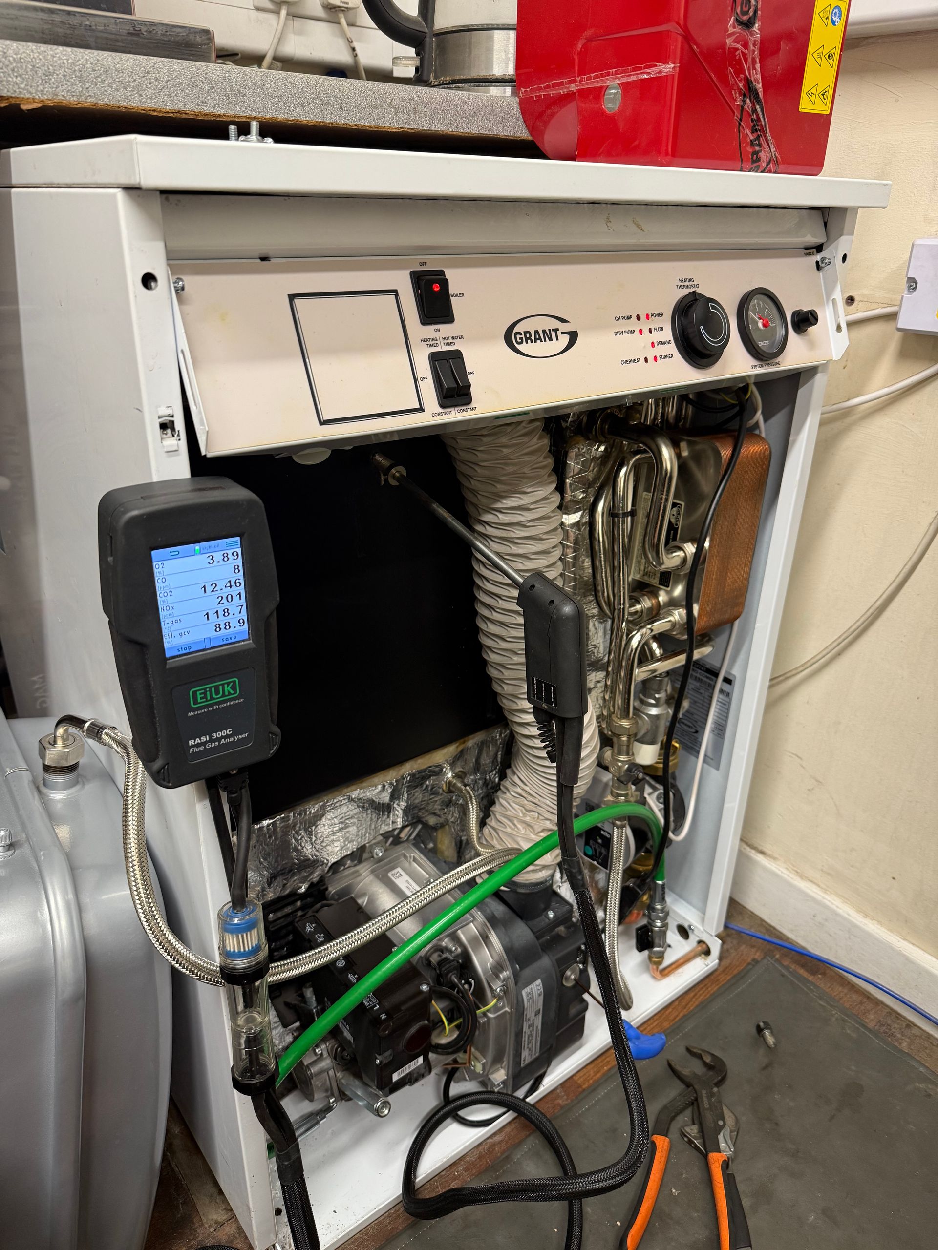 OFTEC registered engineer repairing oil boiler in local home
