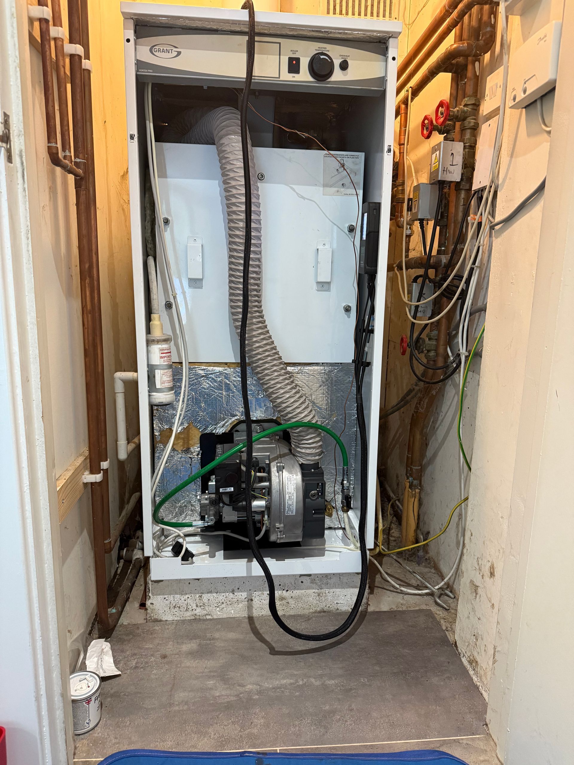 OFTEC engineer servicing an oil boiler in Beenham home