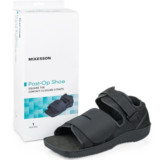 McKesson post-op shoe, black, with adjustable straps, next to its packaging box.