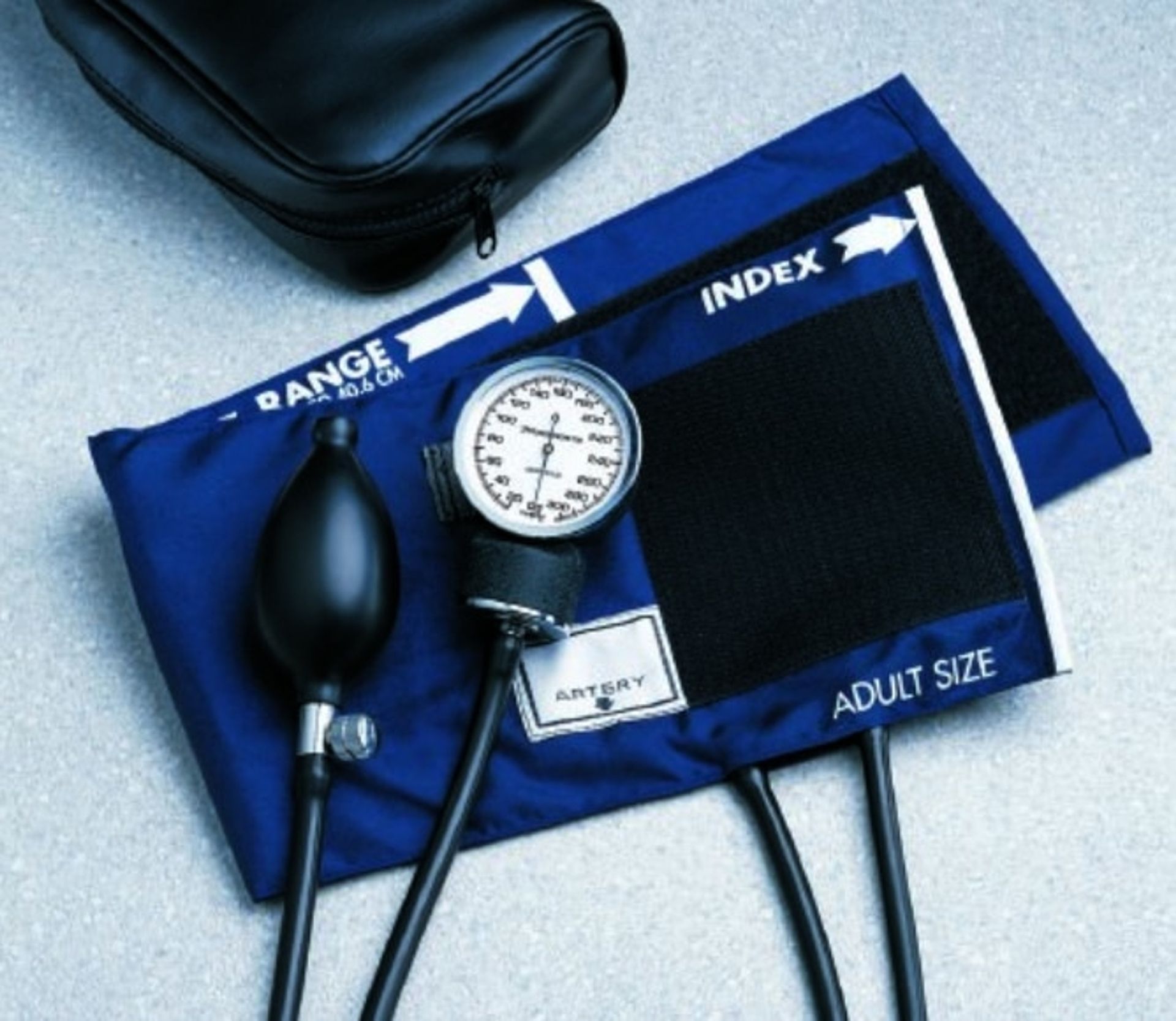 Blue and black adult-size blood pressure cuff with gauge, bulb, and carrying case.