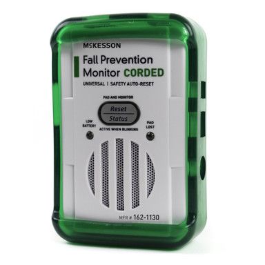 McKesson fall prevention monitor; green casing, white face, corded, with reset button and speaker.