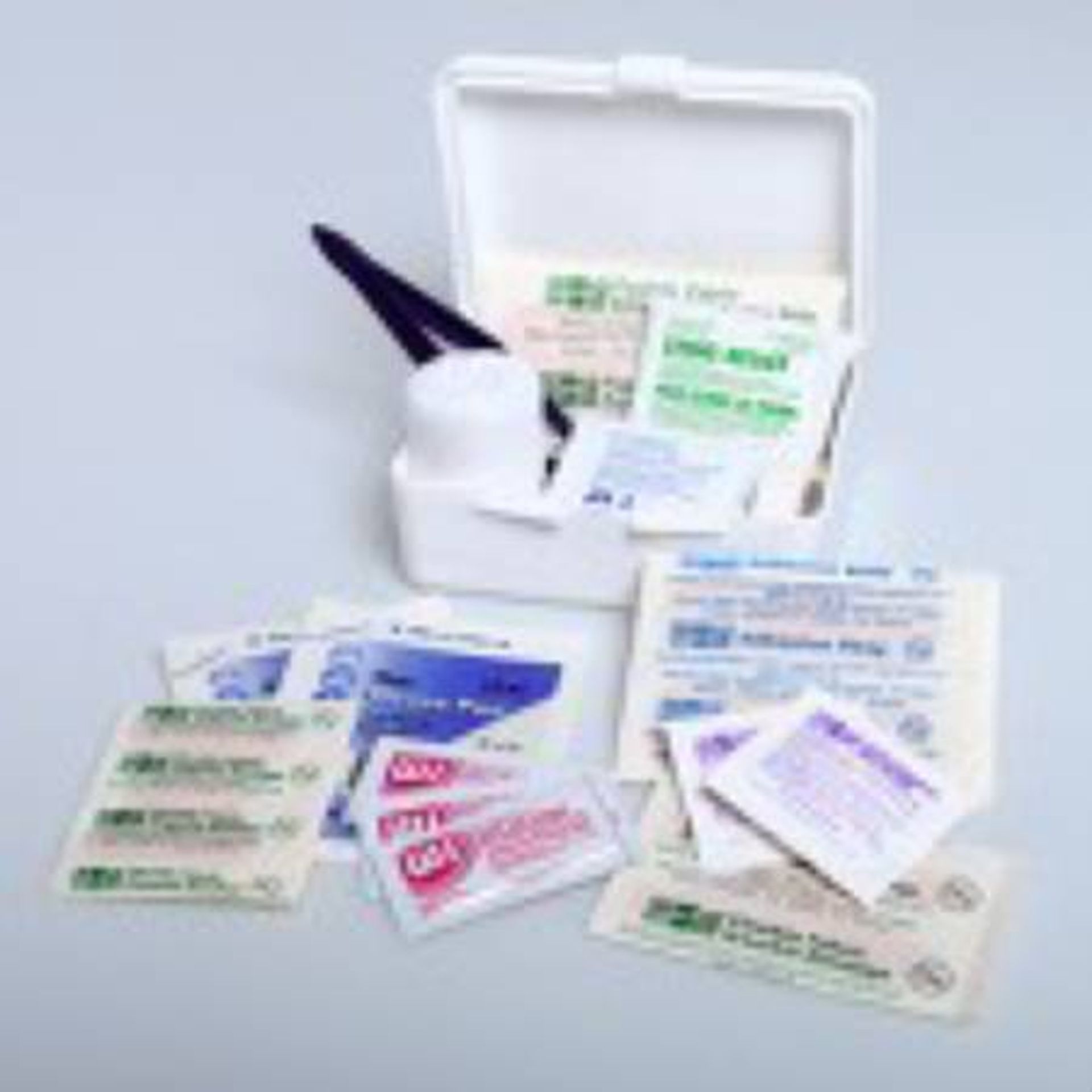 Small open white first-aid kit with bandages, wipes, and a bottle of antiseptic.