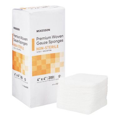 Box of McKesson non-sterile woven gauze sponges, orange and white packaging, a stack of sponges beside the box.