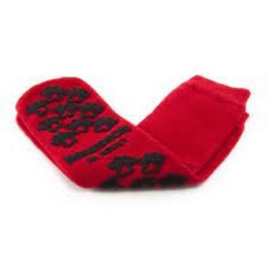 Red sock with black non-slip grips folded on a white surface.