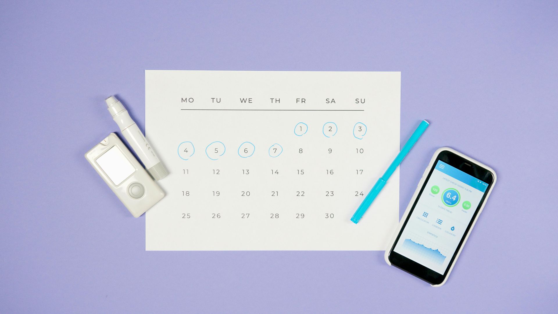 Calendar with ovulation tracker, test, pencil, and phone on purple surface.