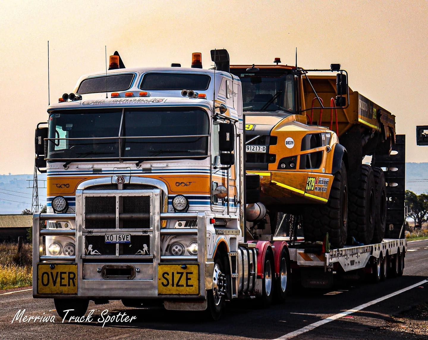 Truck Carrying a Big Yellow Truck — Rutherford, NSW — Goldsprings Heavy Haulage