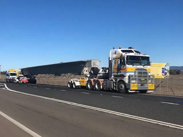 Truck Loaded with Long Steel Beam — Rutherford, NSW — Goldsprings Heavy Haulage