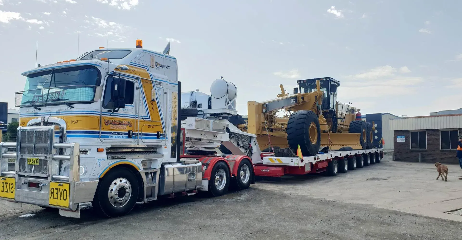 A Large Semi Truck is Carrying a Bulldozer on Its Trailer — Rutherford, NSW — Goldsprings Heavy Haulage