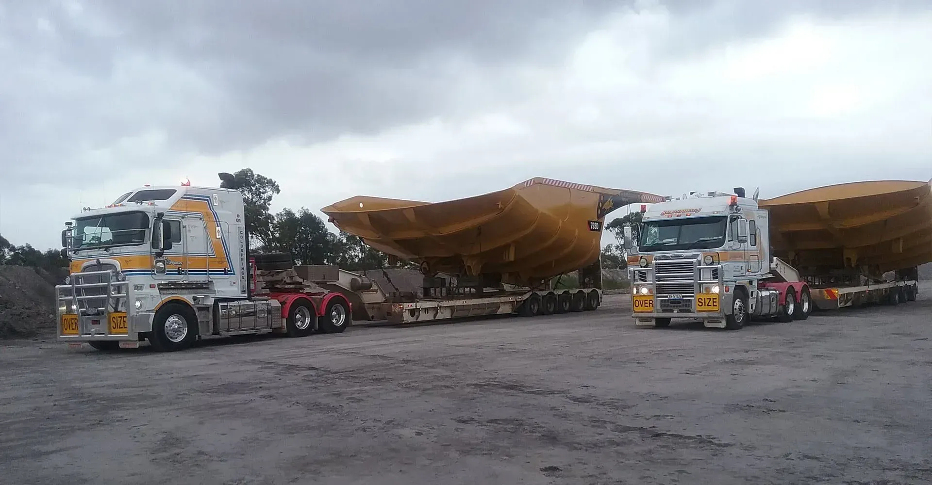 Two Trucks are Parked Next to Each Other in a Parking Lot — Rutherford, NSW — Goldsprings Heavy Haulage
