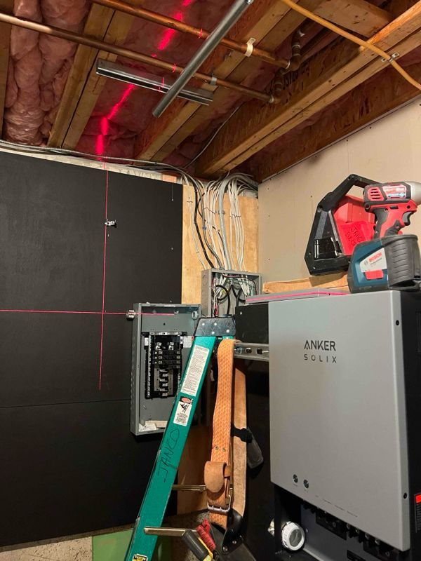 A ladder is sitting next to a machine in a room.