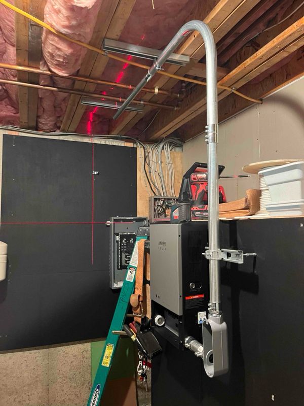 A ladder is hanging from the ceiling of a garage.