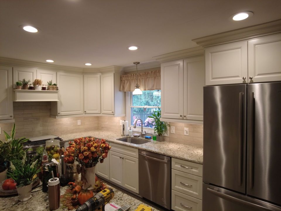 A kitchen with white cabinets and stainless steel appliances