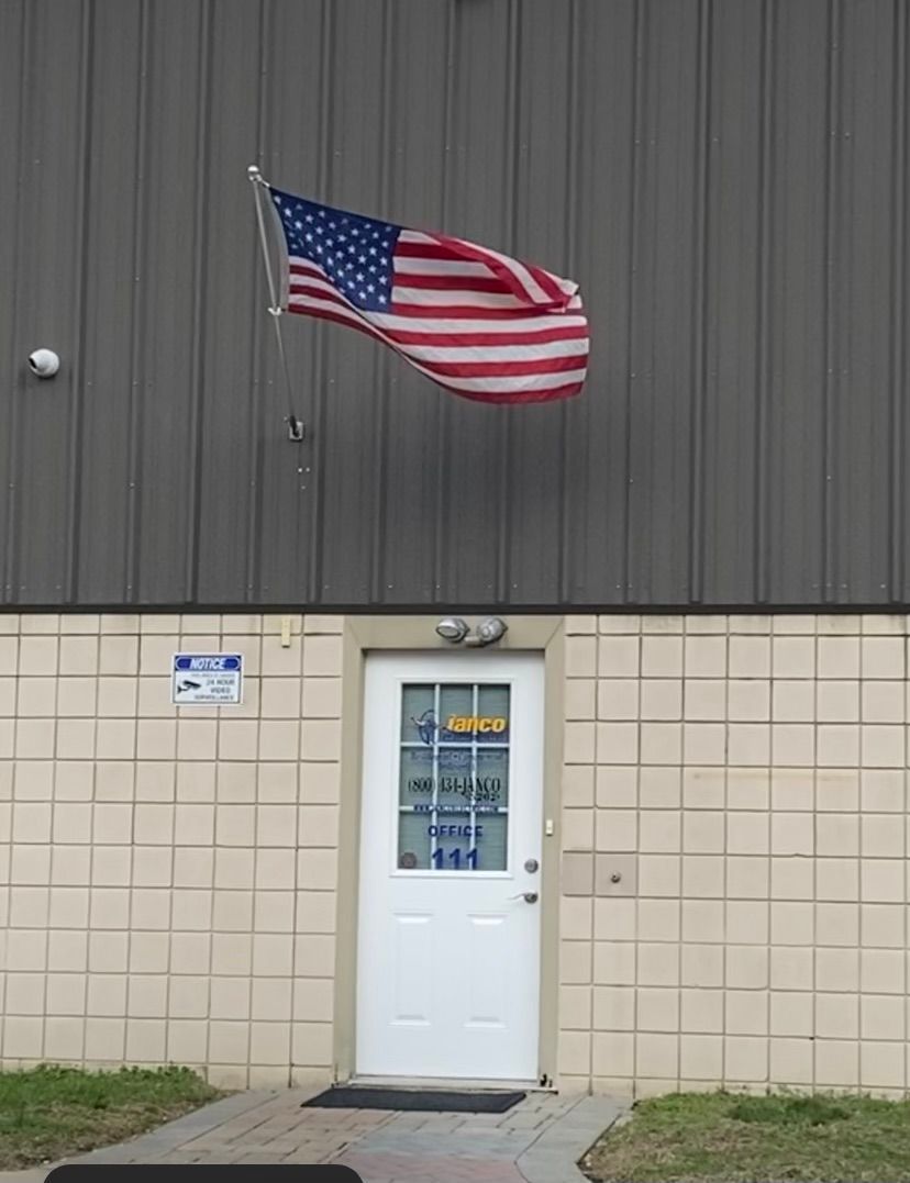 An american flag is flying in front of a building