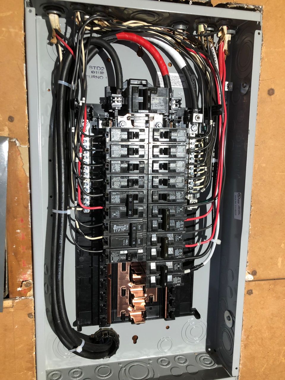 A electrical box with a lot of wires coming out of it.