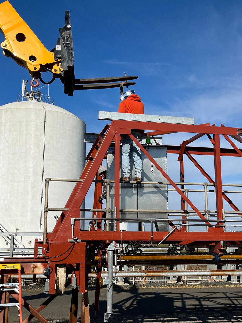 A man is standing on top of a metal structure