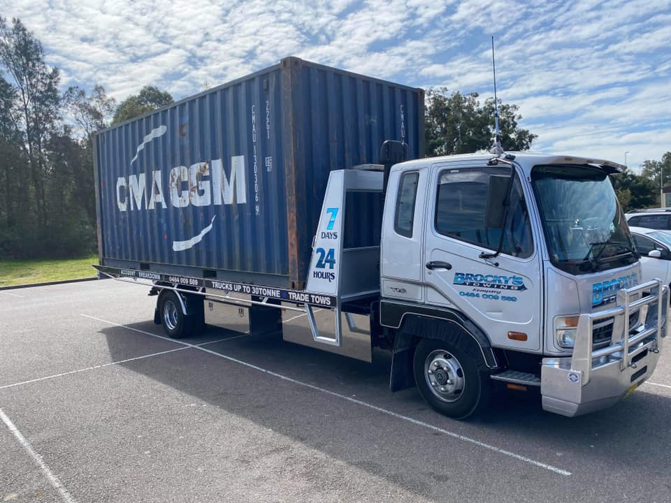 Flatbed Truck Carrying a Shipping Container — Towing in Kempsey