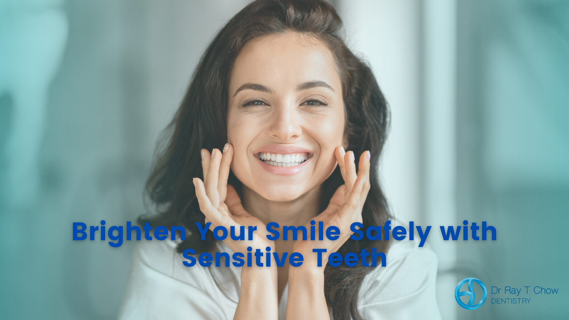 A woman is smiling with her hands on her face.