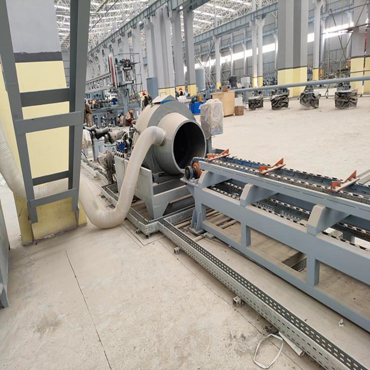 Industrial machine assembling pipes in a factory setting.