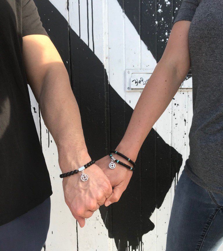 Two people holding hands