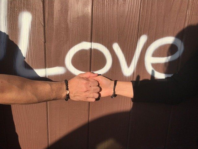 Two hands shaking with Connect bracelets on