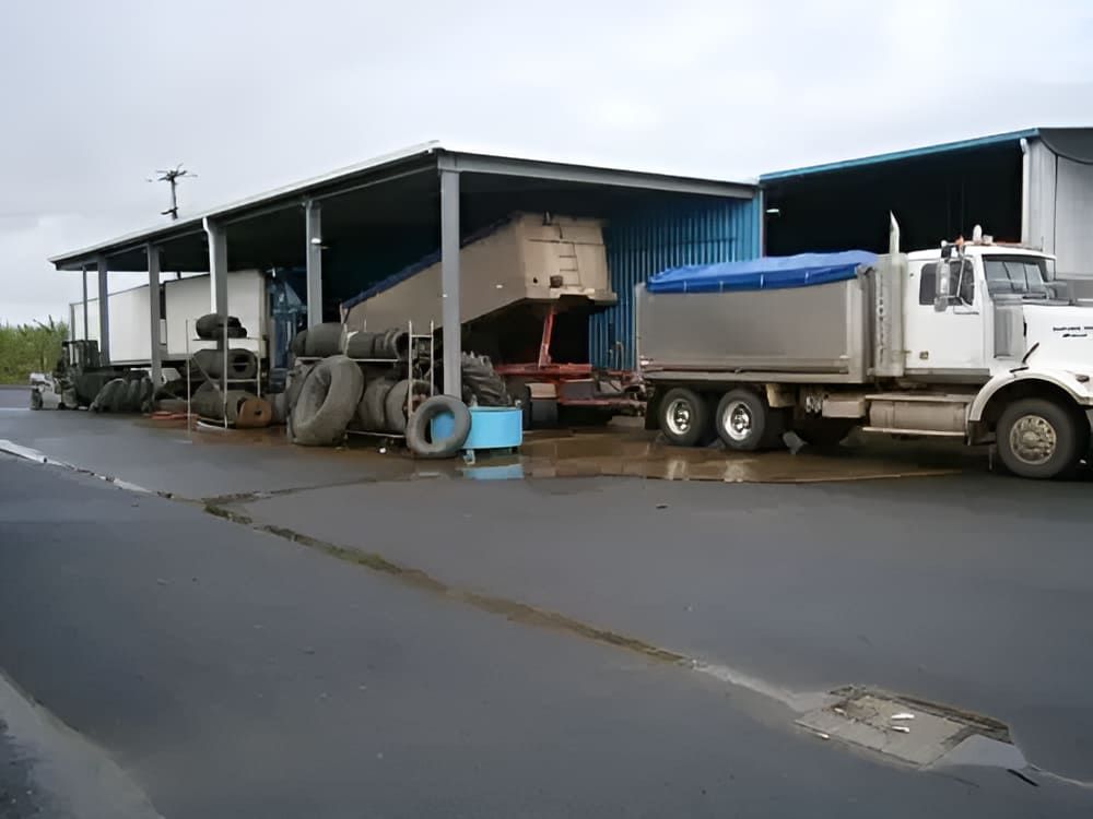 A Dump Truck Is Parked In Front Of A Building — Tyrepower Innisfail In Goondi Bend, QLD