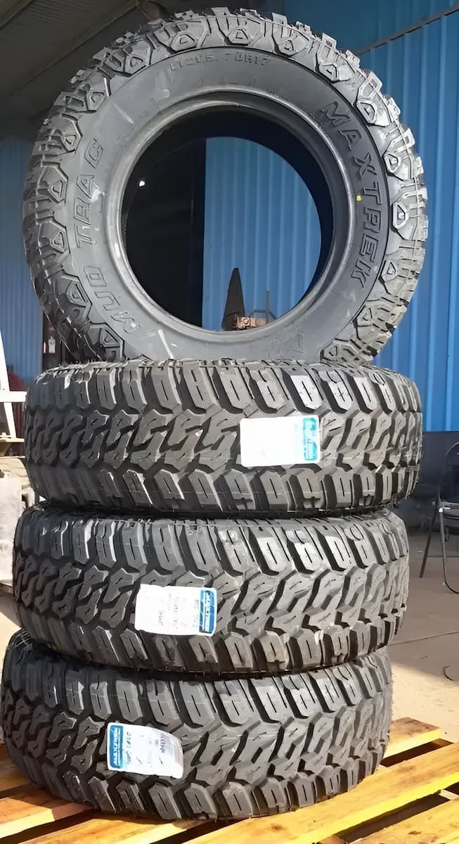 Three Tyres Are Stacked On Top Of Each Other On A Wooden Pallet — Tyrepower Innisfail In Goondi Bend, QLD