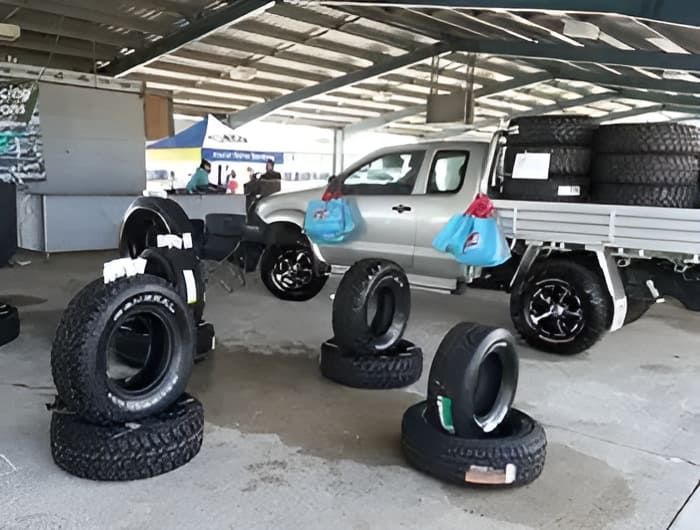 A Truck With A Stack Of Tyres In Front Of It — Tyrepower Innisfail In Goondi Bend, QLD