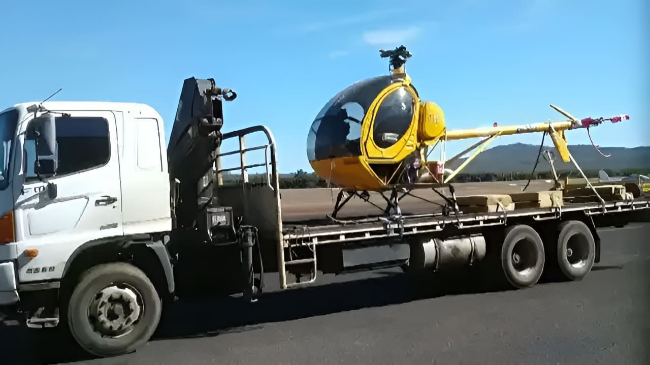 A Yellow Helicopter Is On The Back Of A Flatbed Truck — Tyrepower Innisfail In Goondi Bend, QLD
