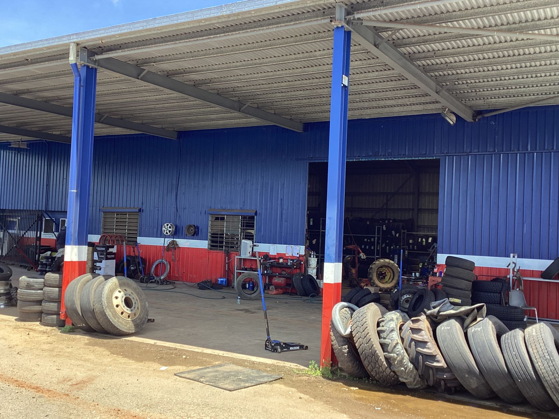 A Dump Truck Is Parked In Front Of A Building — Tyrepower Innisfail In Goondi Bend, QLD