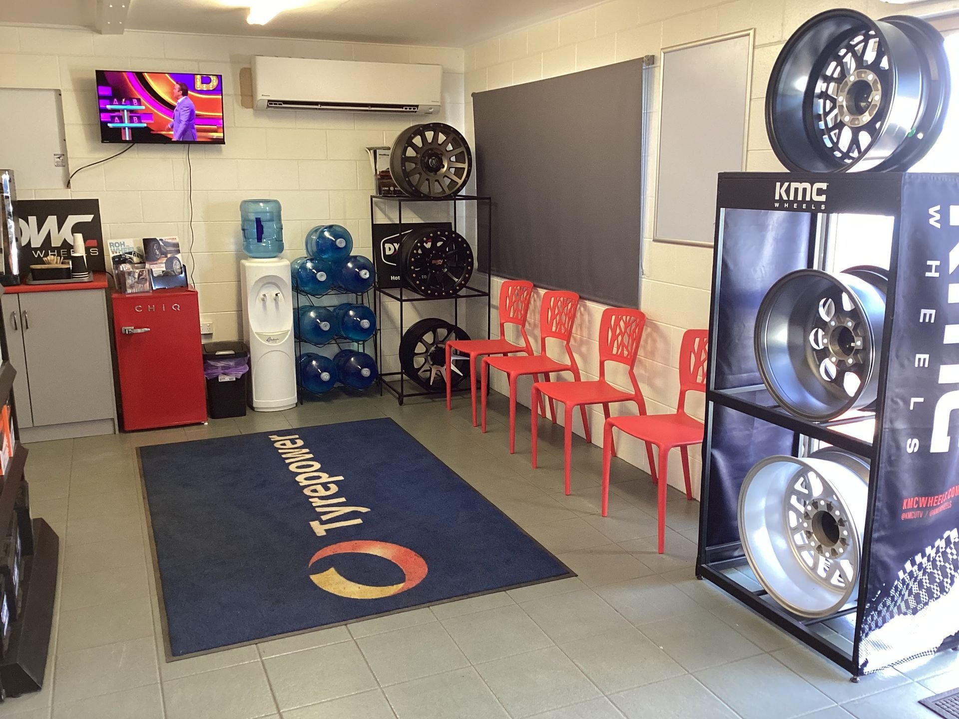 A Man Is Standing Next To A Truck Holding A Clipboard — Tyrepower Innisfail In Goondi Bend, QLD