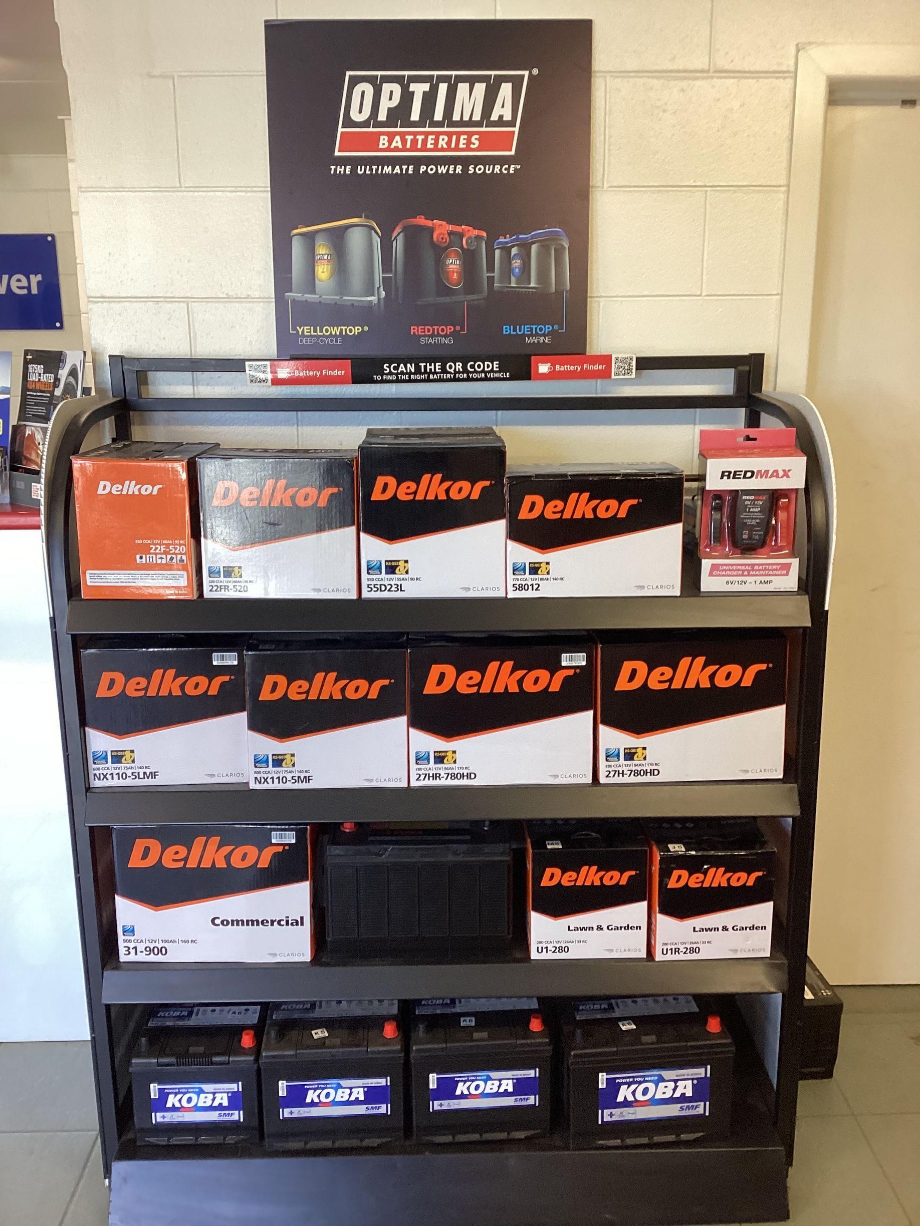 A Man Is Analyzing On The Battery Health Of A Red Car — Tyrepower Innisfail In Goondi Bend, QLD