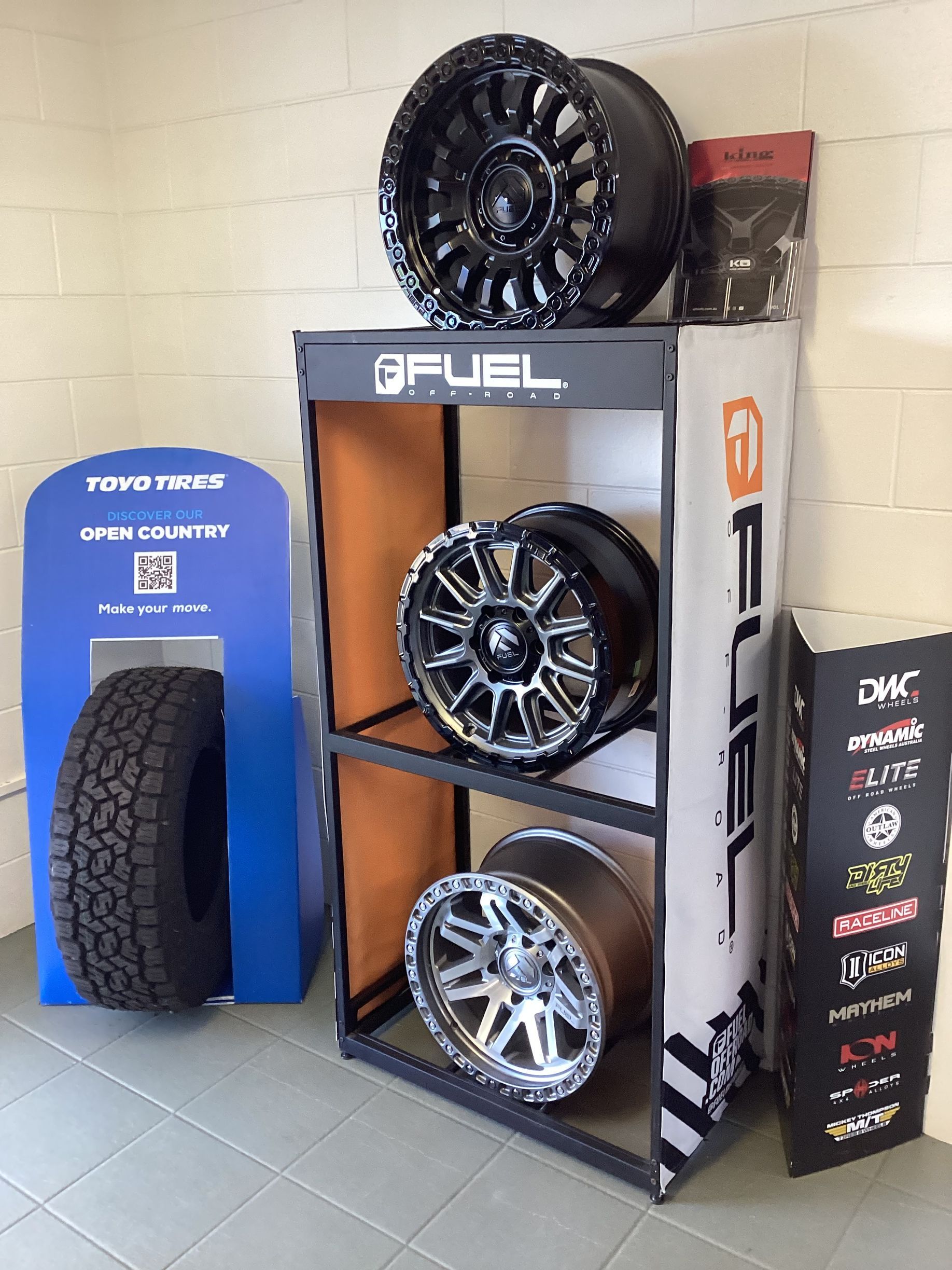 A Person Is Changing A Tyre On A Car With A Wrench — Tyrepower Innisfail In Goondi Bend, QLD