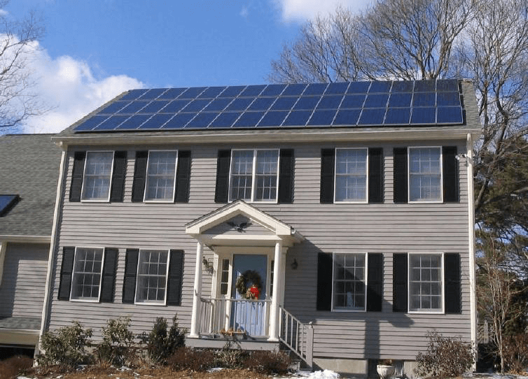 A house with black shutters and solar panels on the roof