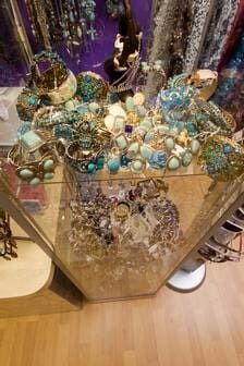 A Glass Display Case Filled With Bracelets And Necklaces On A Wooden Floor — Ballistic Chix In Forster, NSW