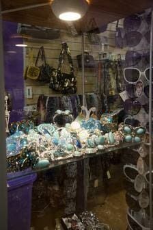 A Display Case Filled With Lots Of Sunglasses And Handbags In A Store — Ballistic Chix In Forster, NSW