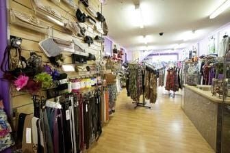 A Woman Is Standing In A Clothing Store With A Lot Of Clothes On Display — Ballistic Chix In Forster, NSW