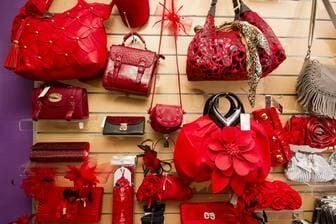 A Bunch Of Red Handbags Are Hanging On A Wall — Ballistic Chix In Forster, NSW