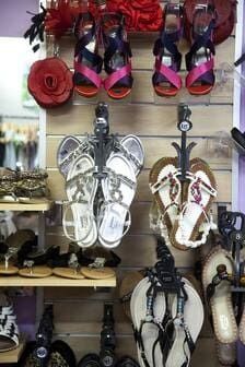 A Display Of Sandals Hanging On A Wall In A Store — Ballistic Chix In Forster, NSW