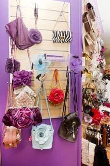 A Bunch Of Handbags Are Hanging On A Wall In A Store — Ballistic Chix In Forster, NSW