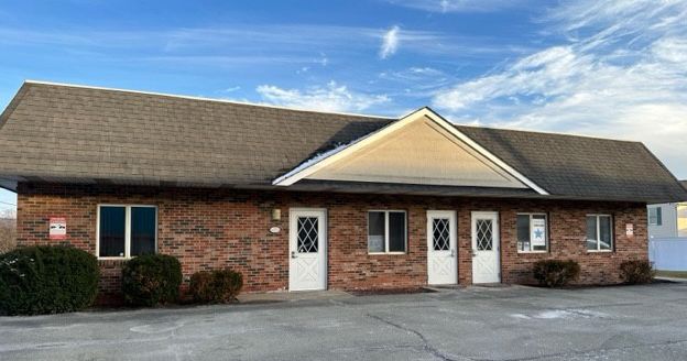 A Small Brick Building With A Roof And A Lot Of Windows And Doors - Latrobe, PA - Laser180