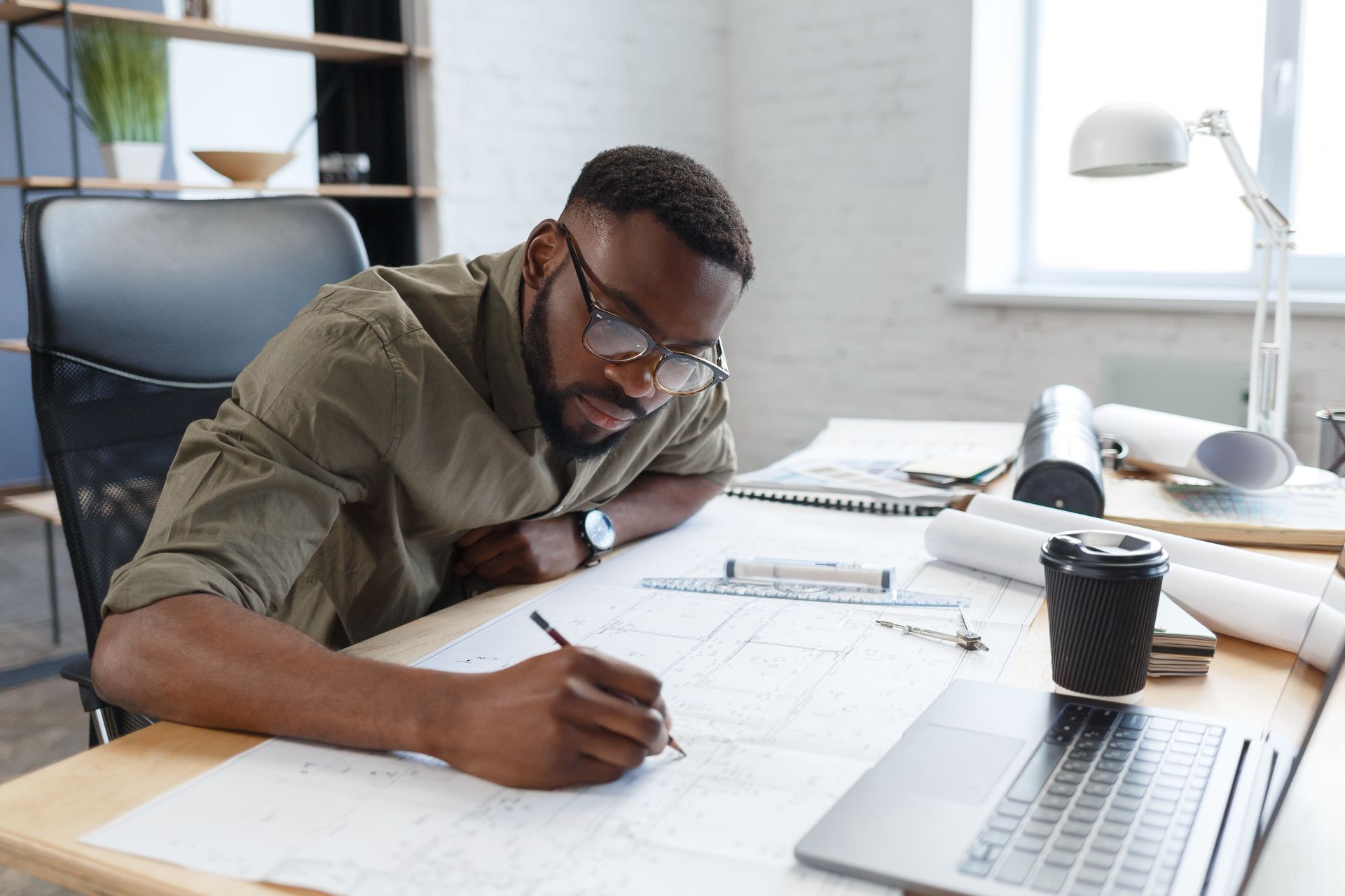 An architect working in an office performs a design and drafting service for a project.