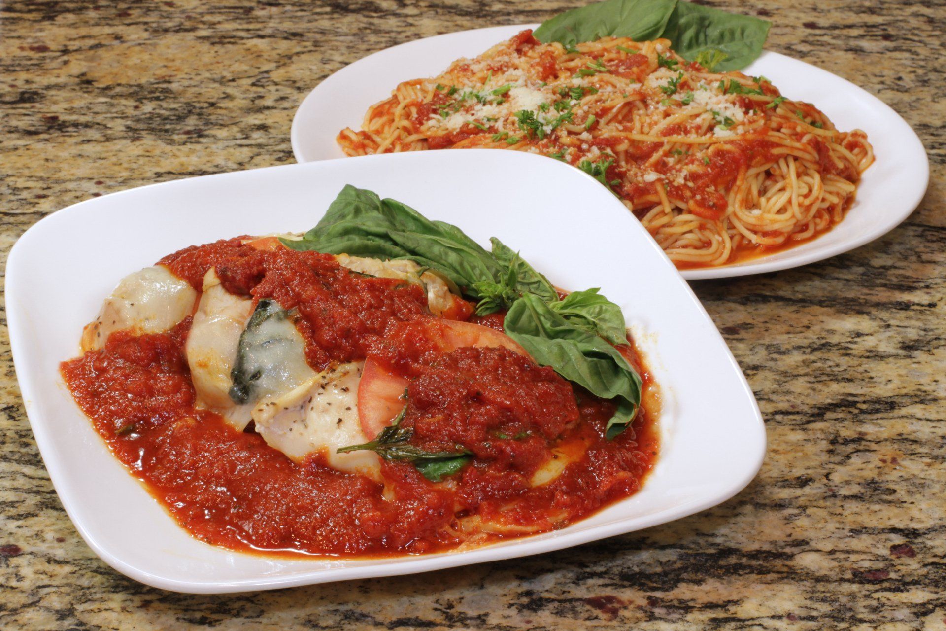 Two plates of food are sitting on a table.