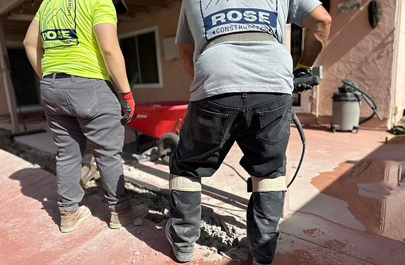 A brick driveway leading to a house surrounded by bushes and trees.