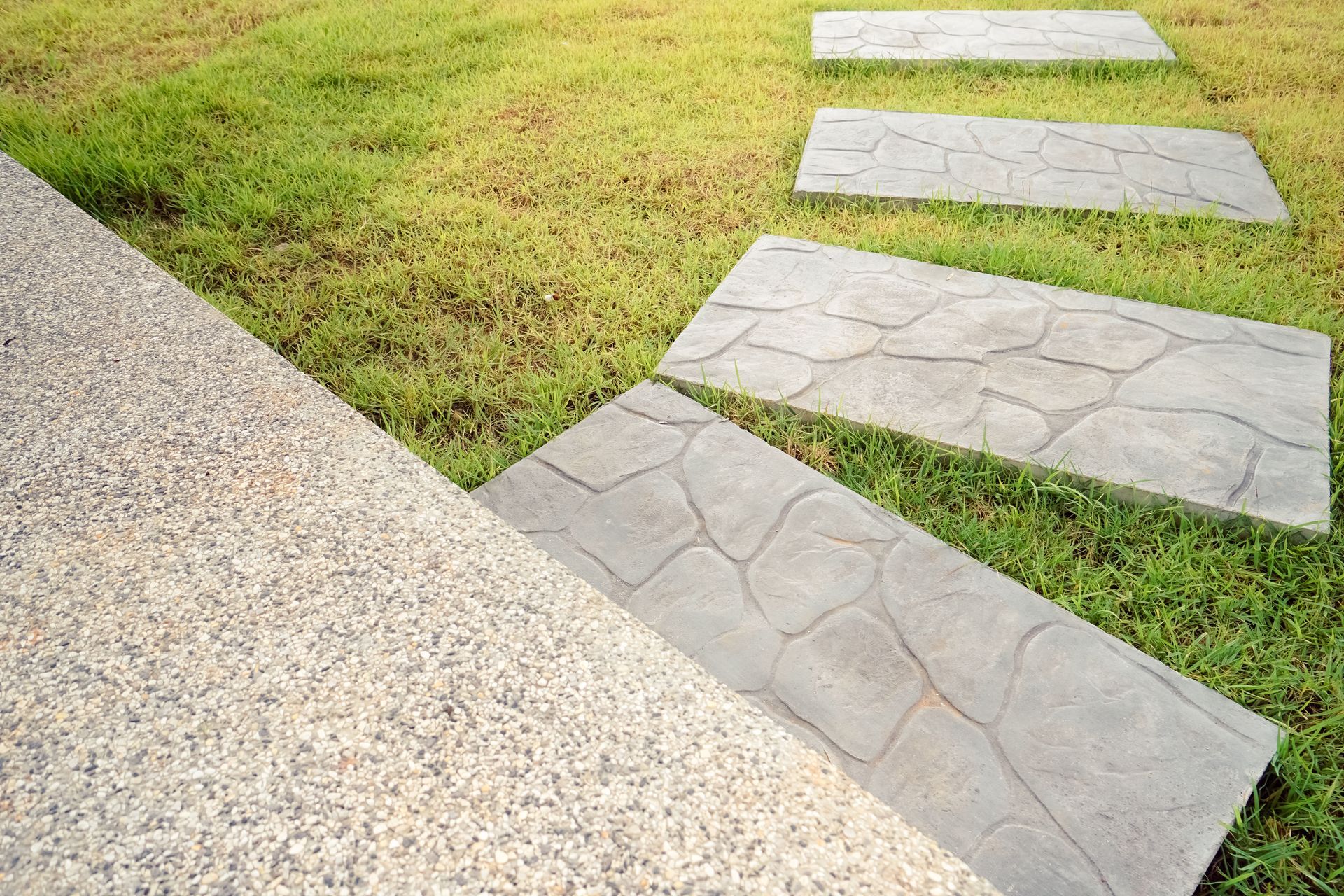 Waypoint Concrete poured a residential broom-finish concrete driveway with gravel trim in Meridian, Idaho.