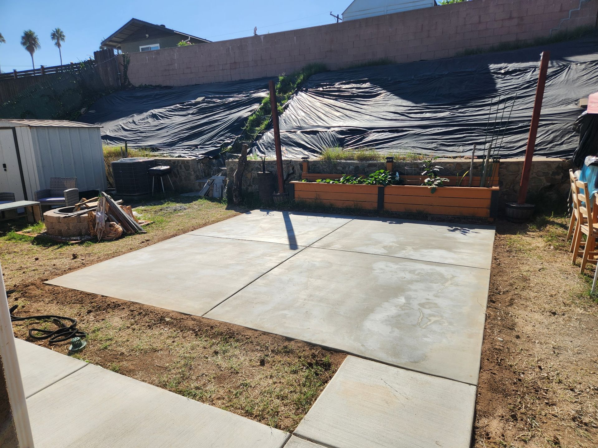 A large house with a patio and umbrella in front of it.